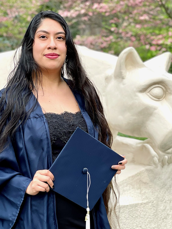 photo of female graduate in front of lion shrine